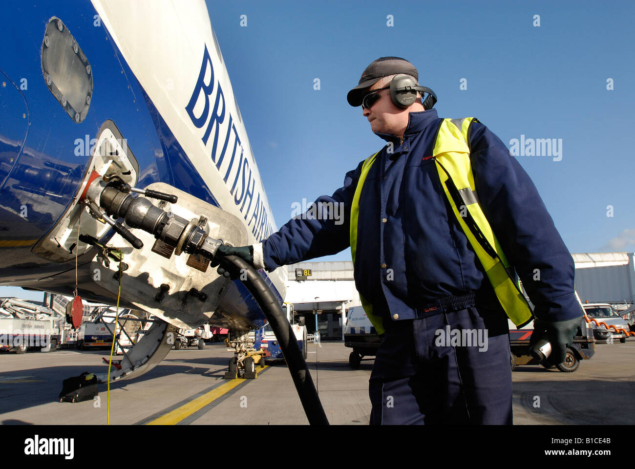 Technician refuelling aircraft Stock Photo