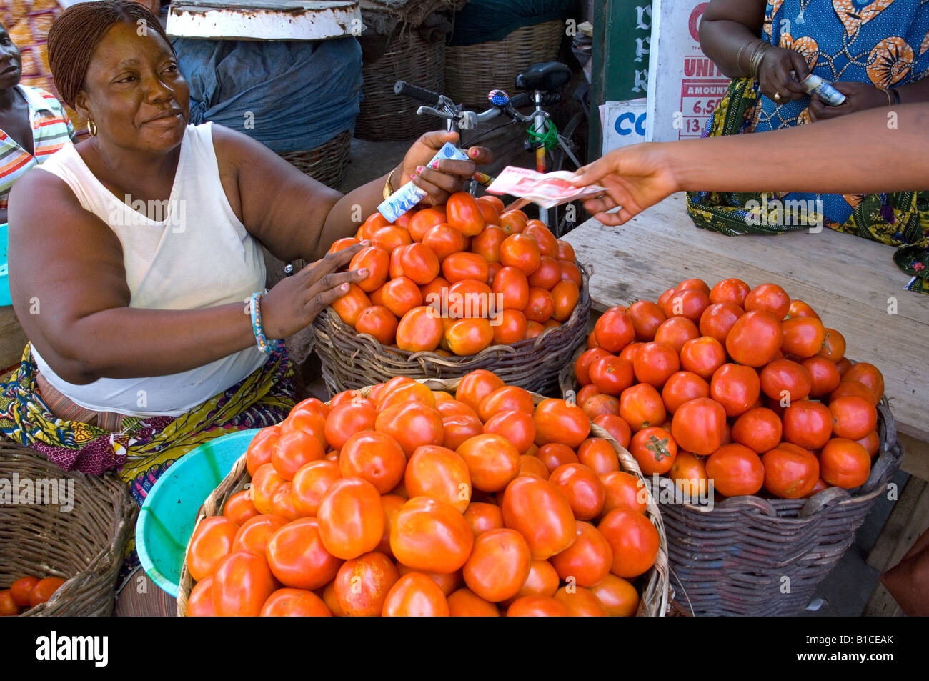 African woman selling tomatoes in a market in Accra, Ghana Stock Photo