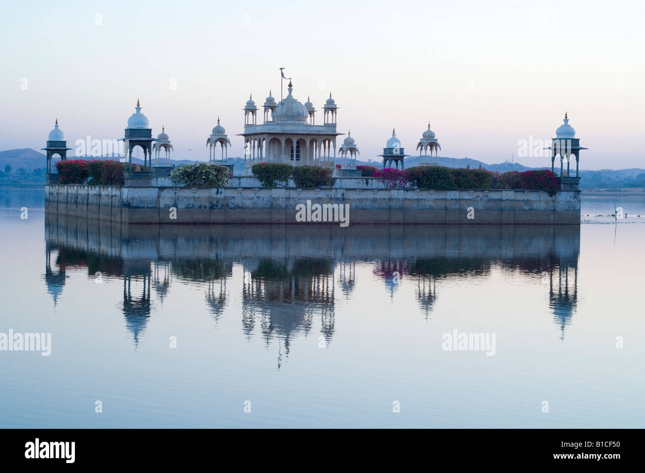 udai bilas palace rajasthan india lake temple at dusk Stock Photo