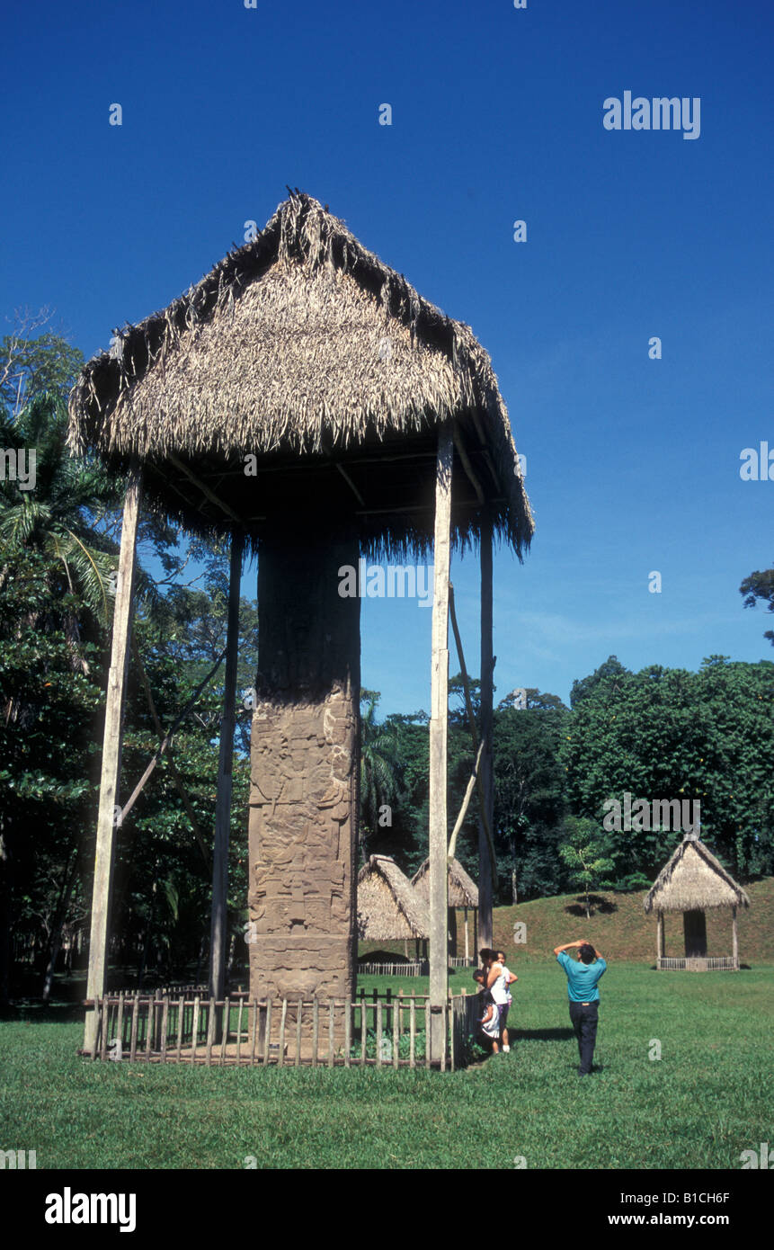 Visitors looking ip at Stela E the tallest stela in the Mayan world Quirigua archaeological site Guatemala Stock Photo