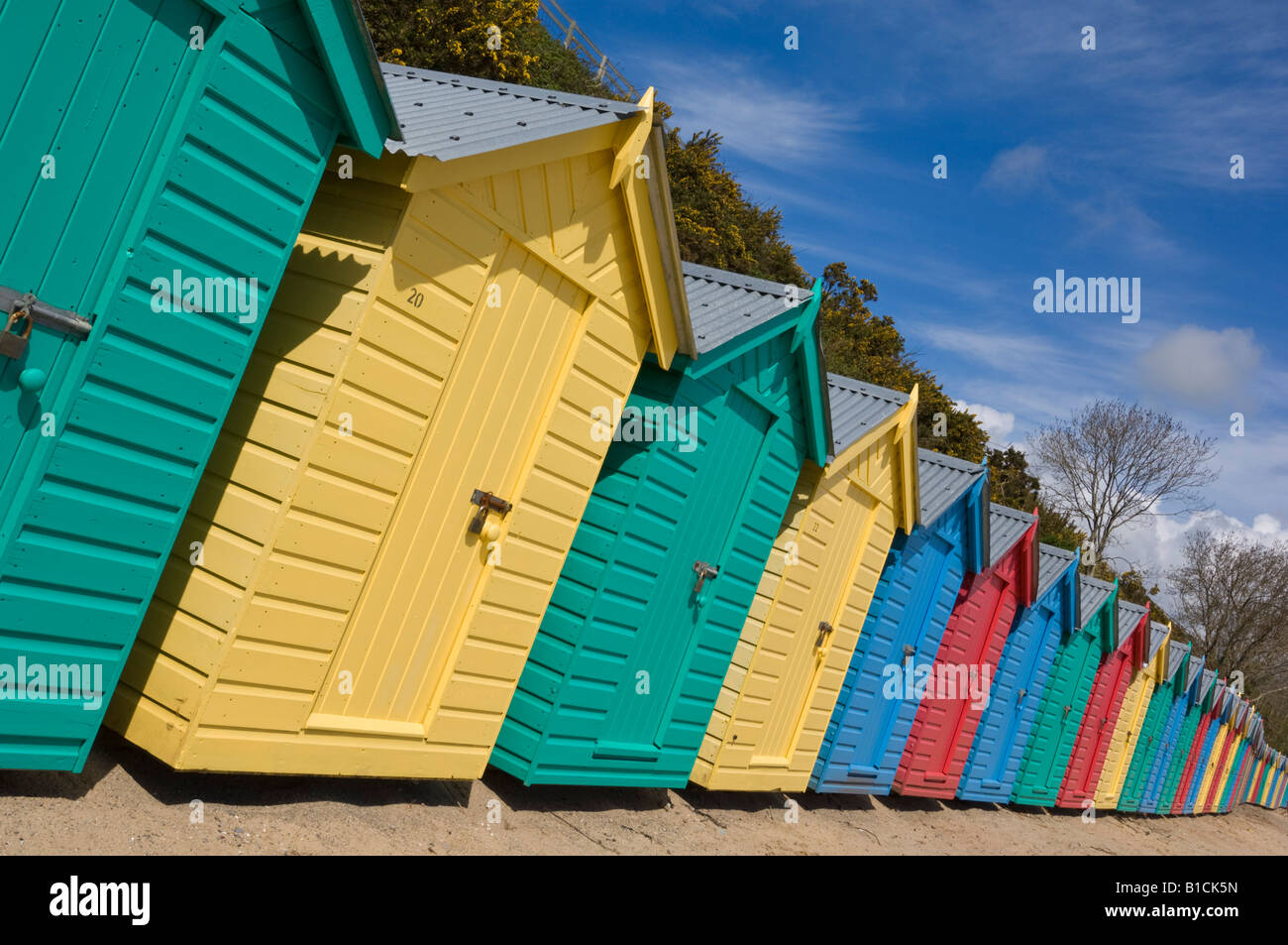 Multicoloured beach huts on the long sweeping beach of Llanbedrog LLyn Peninsula Gwynedd North Wales GB UK EU Europe Stock Photo