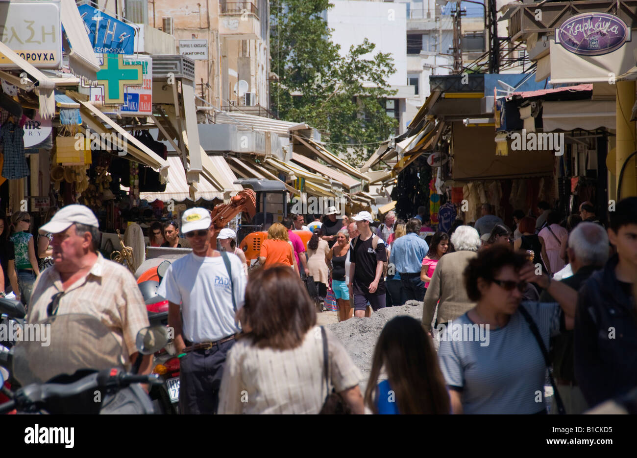 Shops opening onto narrow street giving market feel in Heraklion capital  and largest city on Greek Mediterranean island of Crete Stock Photo - Alamy