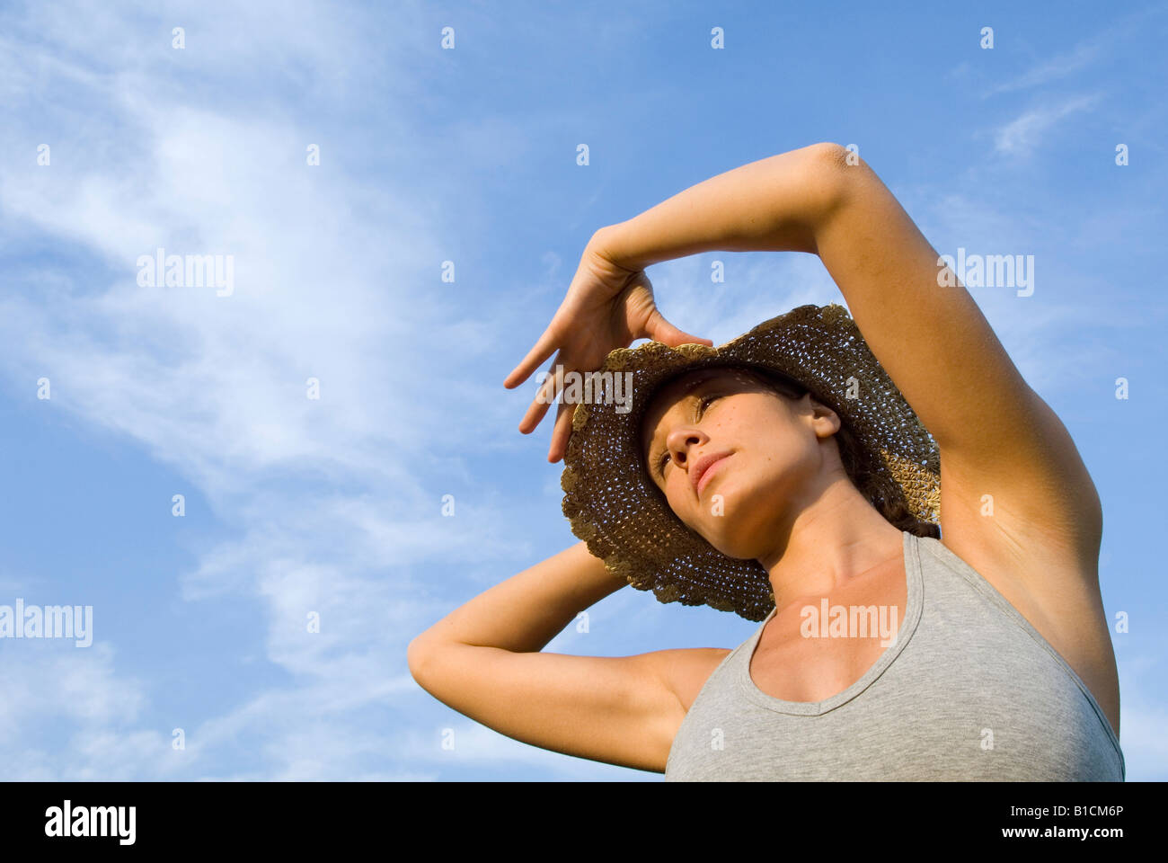 portrait young woman with straw hat, meditative view Stock Photo - Alamy