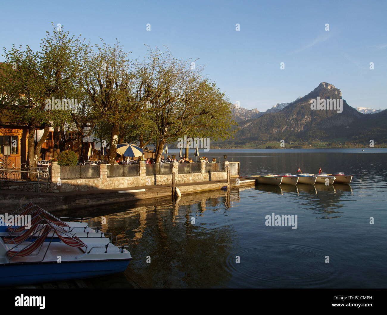 paddleboats and a restaurant at lake Wolfgangsee, Austria, Salzburg, Salzkammergut, St. Wolfgang Stock Photo