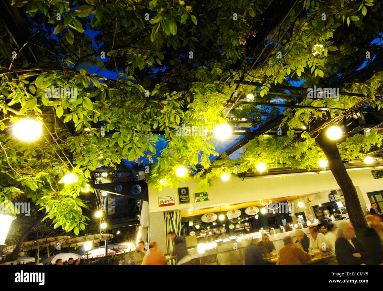 people in the beer garden Schweizerhaus at the amusement park Wiener