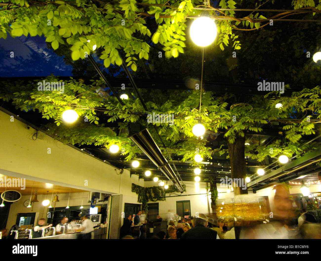 people in beer garden Schweizerhaus at the amusement park Wiener Prater