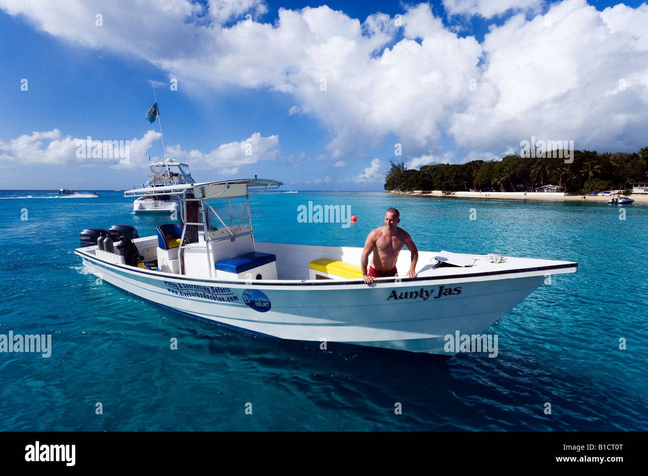 Man in a motorboat Sandy Lane Bay Barbados Caribbean Stock Photo - Alamy