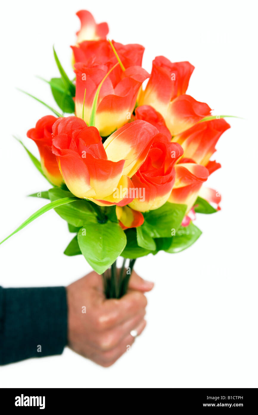 Silk flowers man's hand Stock Photo