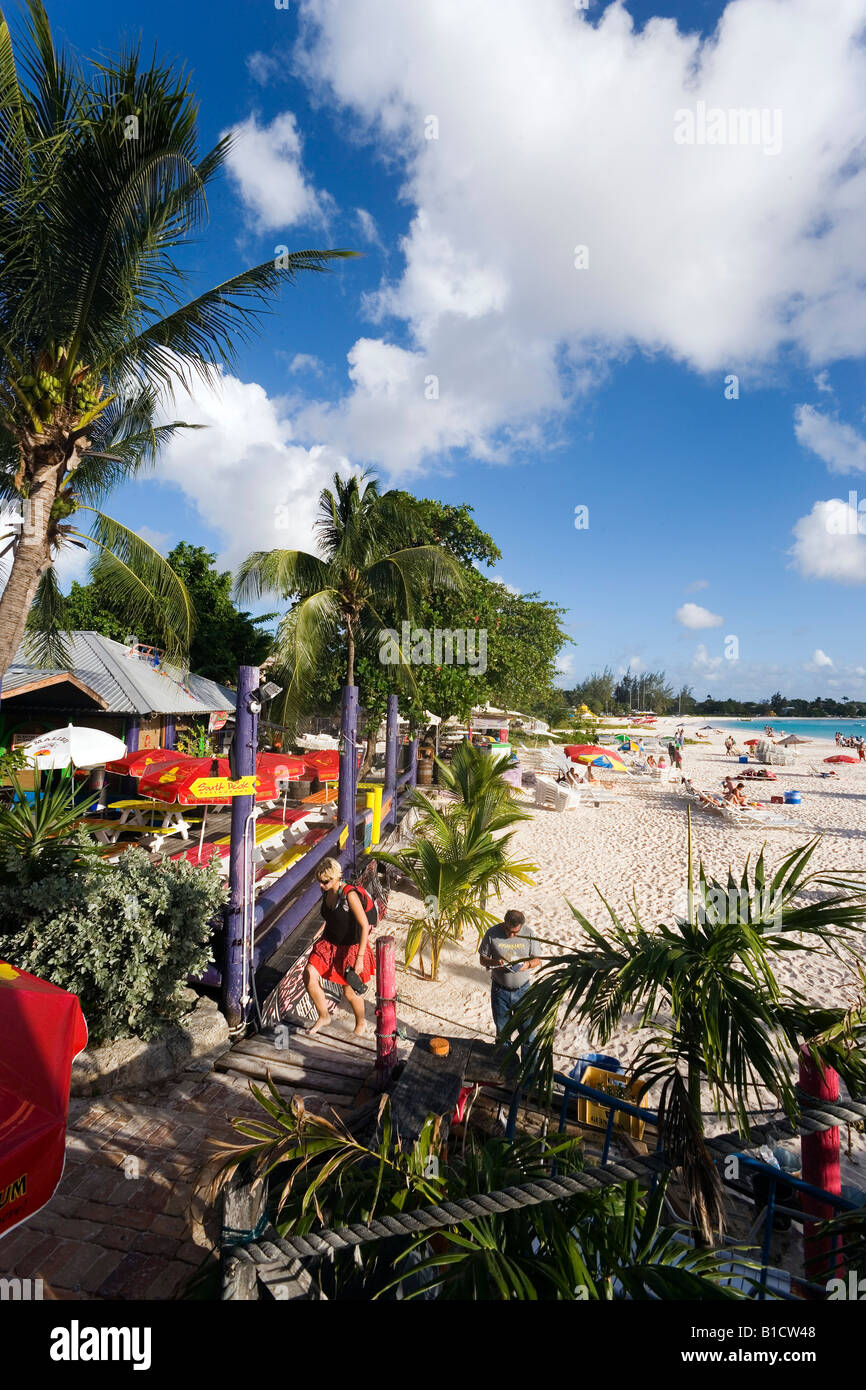 People relaxing at beach near the Boatyard beach bar Bridgetown Barbados Caribbean Stock Photo