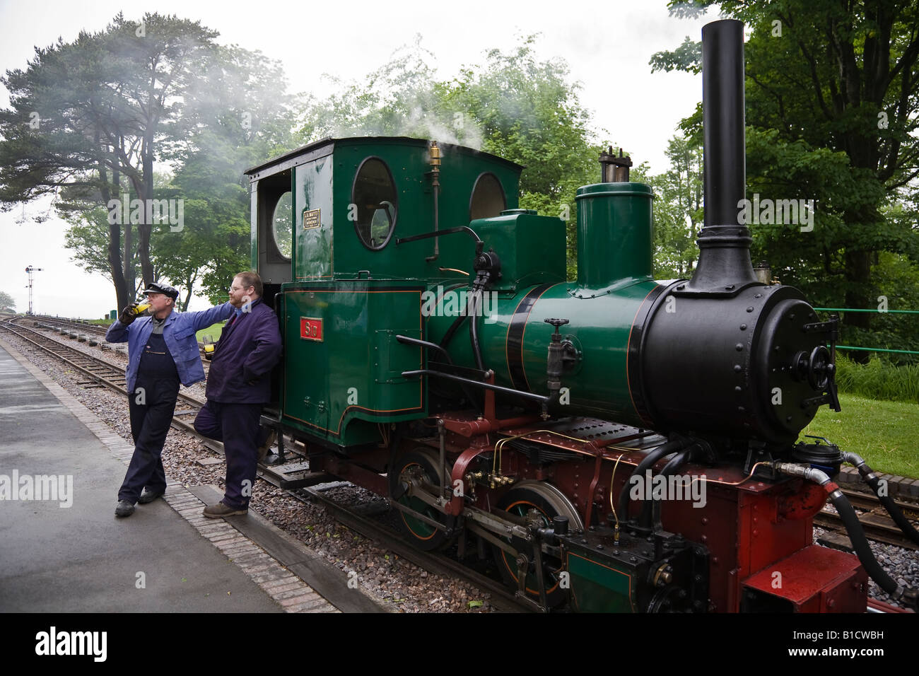 Engine crew relaxing between trips at Woody Bay station, Lynton and Barnstaple Railway, Devon, England Stock Photo