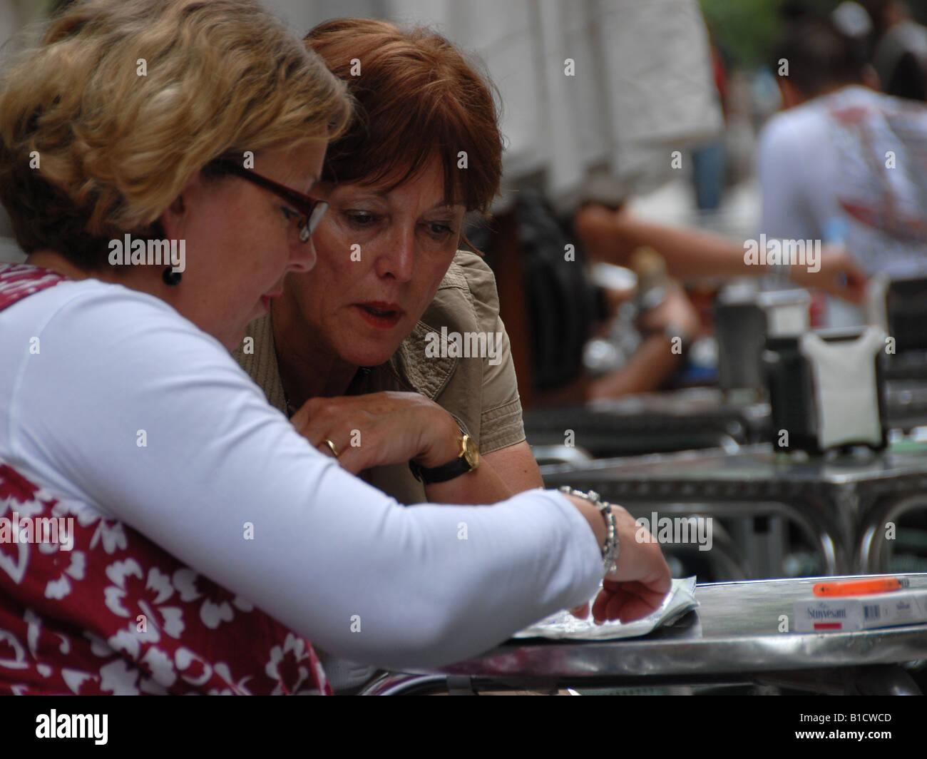 Two ladies a packet of cigarettes and a puzzle Stock Photo