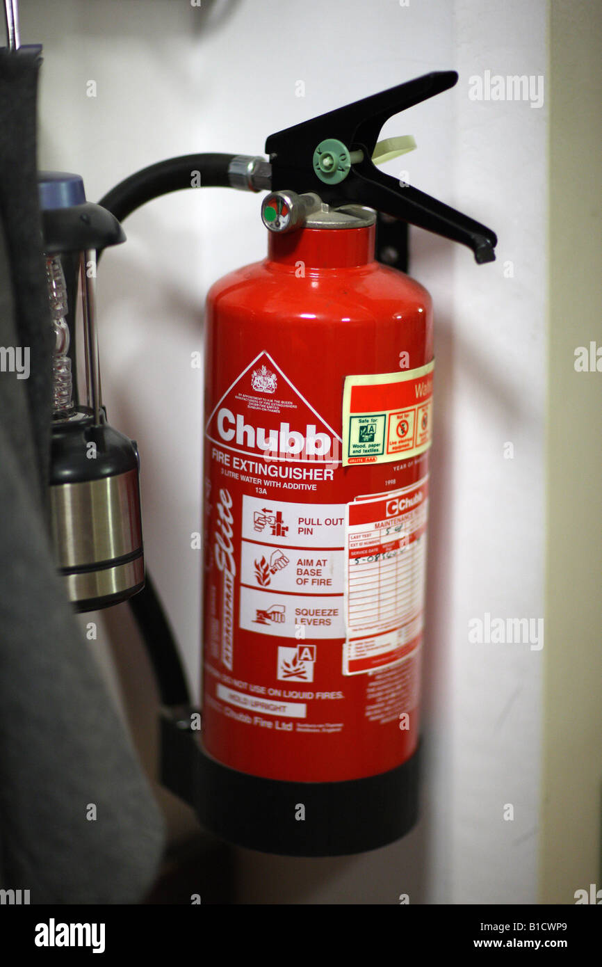 Fire extinguisher fire extinguisher mounted to wall hires stock