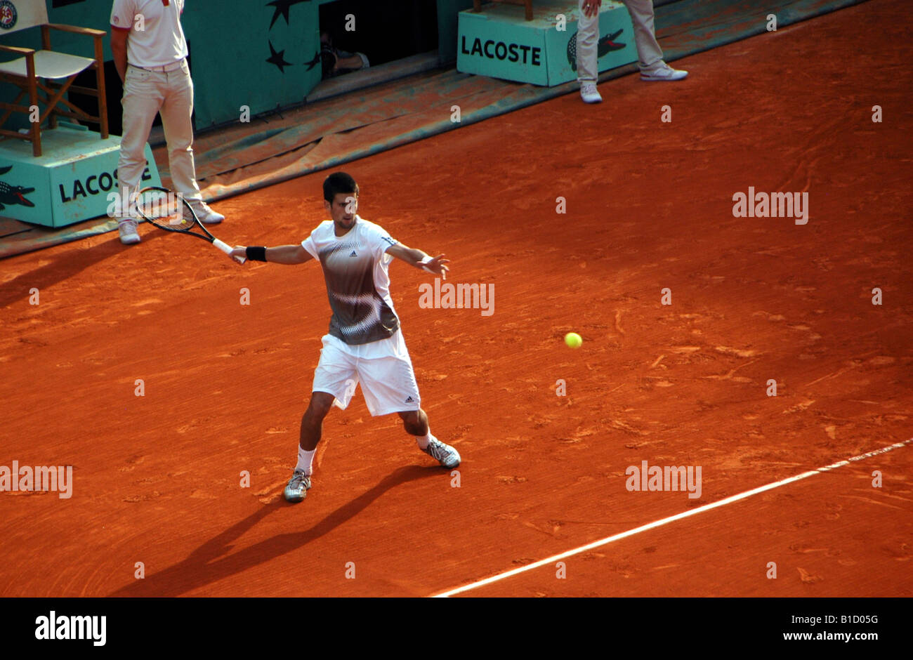 Novak Djokovic hitting a forehand groundstroke at Rolland Garros during the 2008 French Open Stock Photo