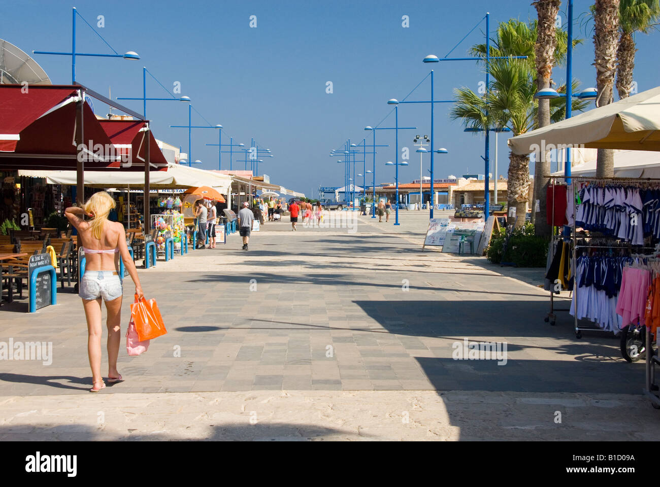 Young Woman in Summer Clothes Shopping at the Shops and Restaurants on the Promenade by the Harbour Agia Napa Cyprus Stock Photo