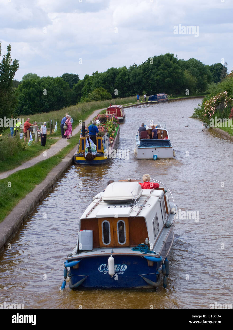 Two Holiday Pleasure Boats Pass Narrow Boat Decked in Flowers Going to