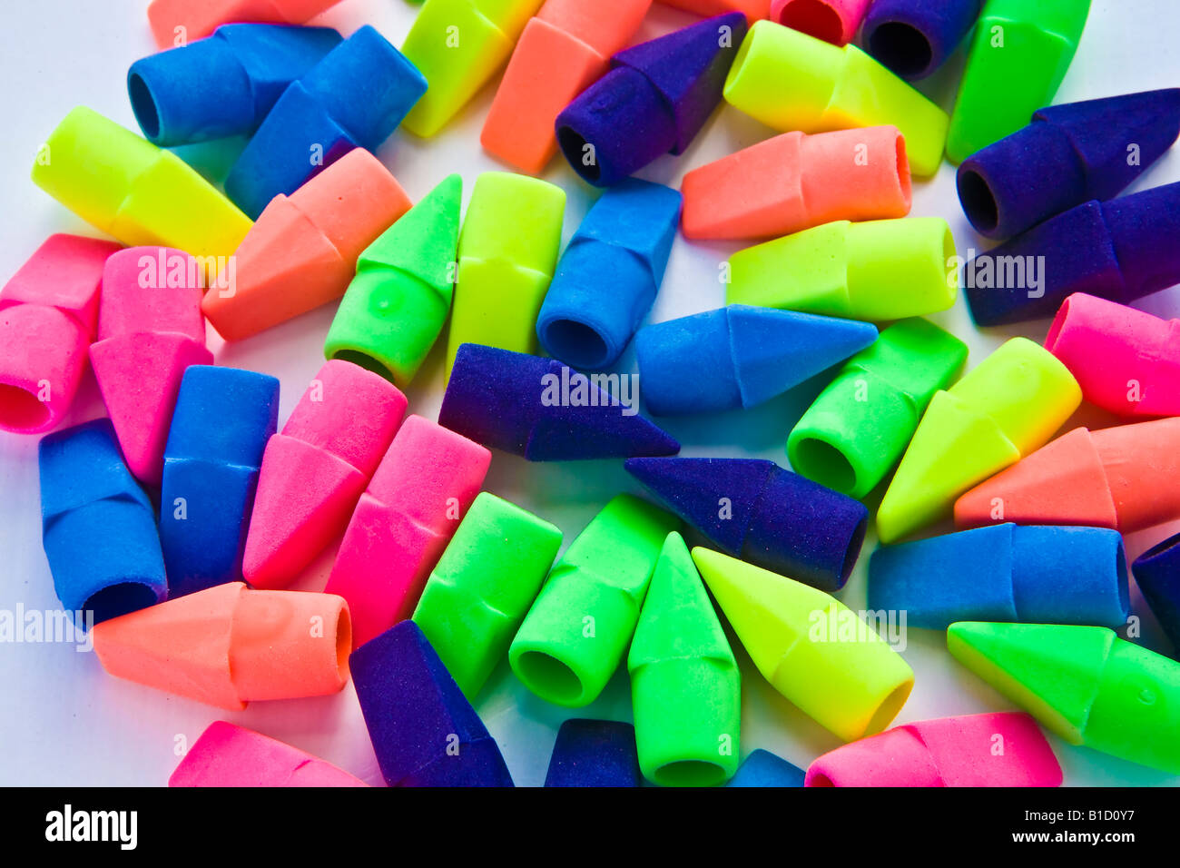Pile of multicolored pencil erasers on white background Stock Photo