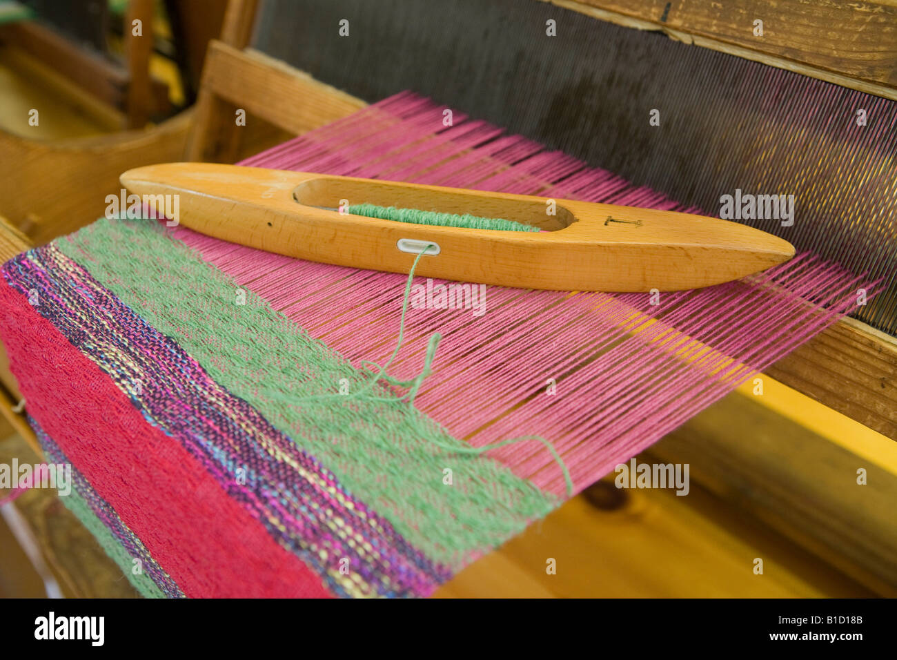 Material and shuttle on a weaving loom Stock Photo Alamy
