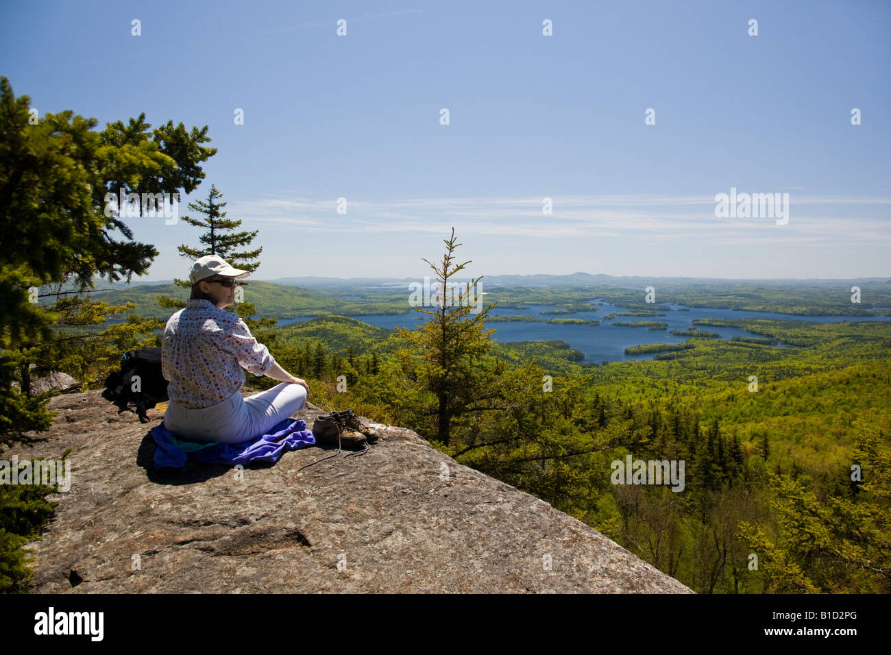 Female hiker enjoying the view of Squam Lake and Lake Winnipesaukee