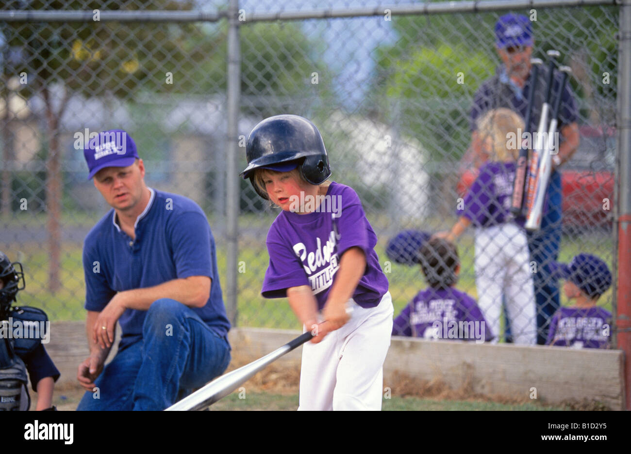 USA OREGON REDMOND A young girl plays Little League T Ball with a local