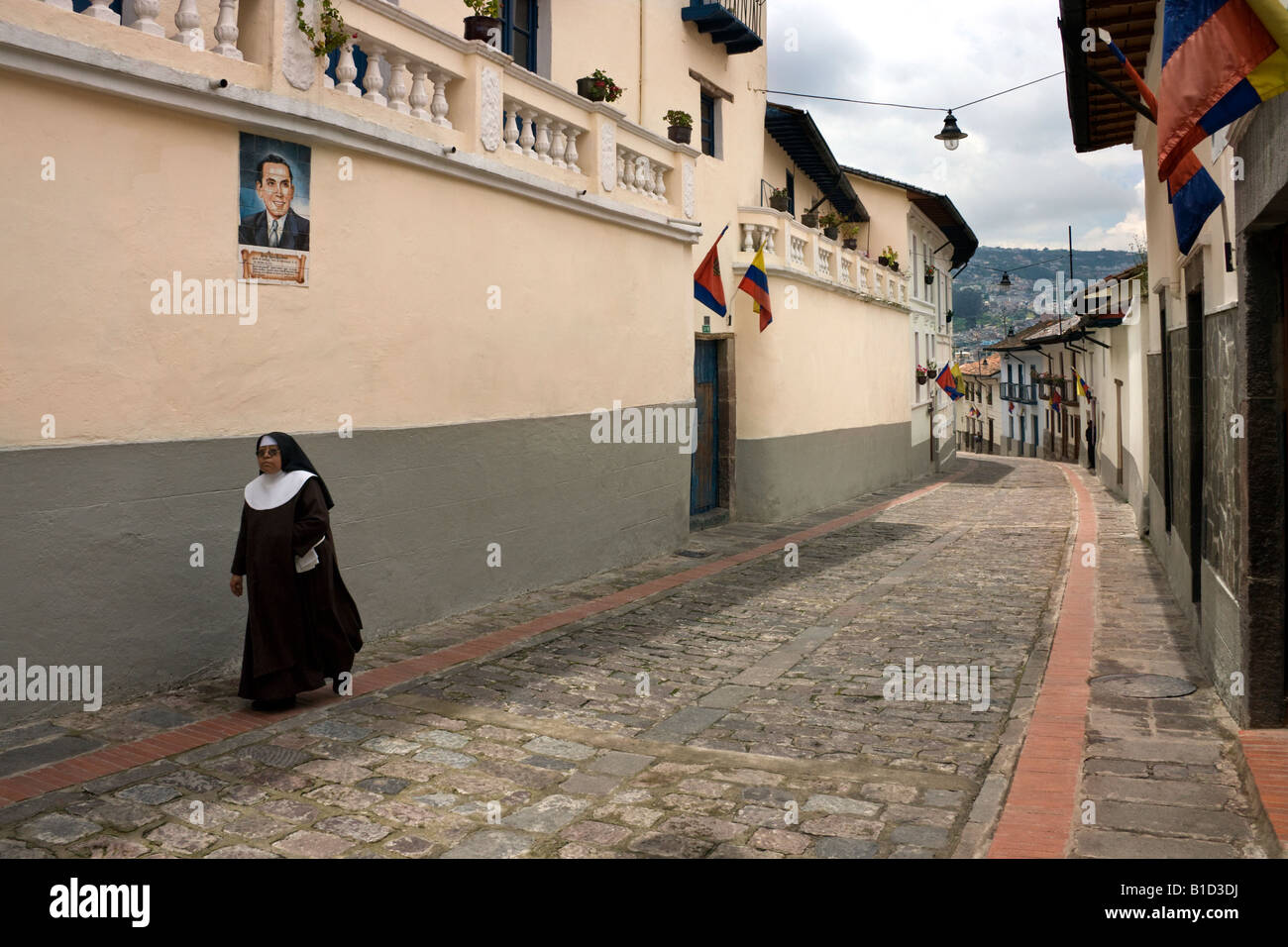 Nun walking up the old colonial street of Calle Ronda in Quito in Ecuador in South America Stock Photo