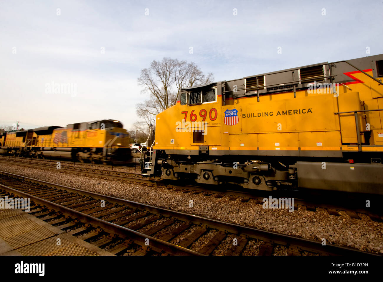 Two Union Pacific trains pass, one at a high rate of speed. Stock Photo