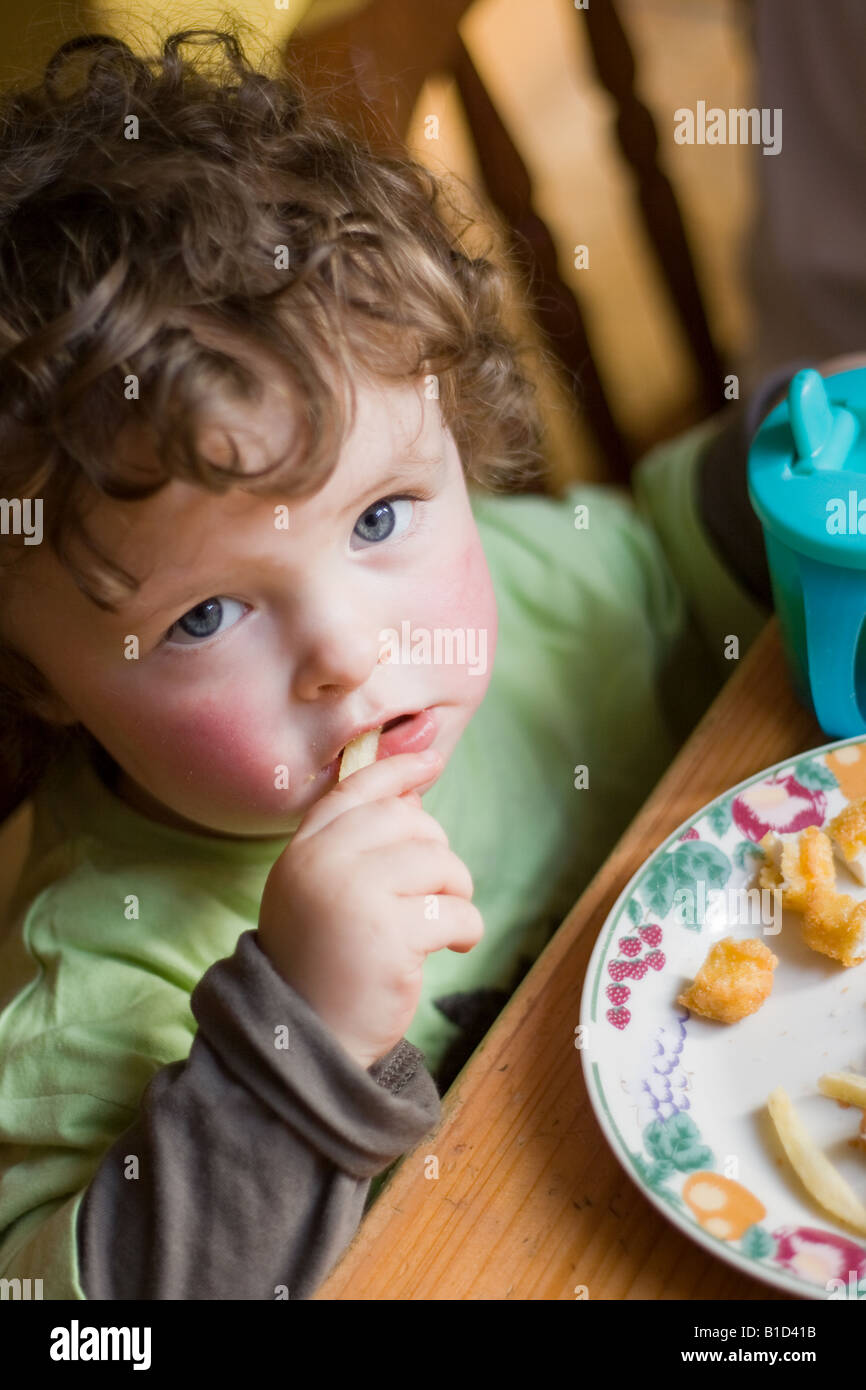 Boy eating french fries table hi-res stock photography and images - Alamy