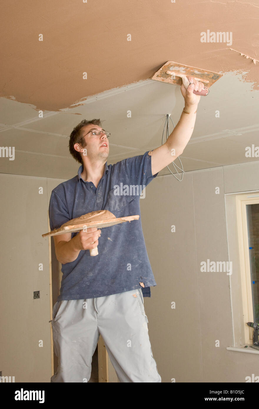 A Plasterer Skimming A Ceiling In A New Home Stock Photo 18114836