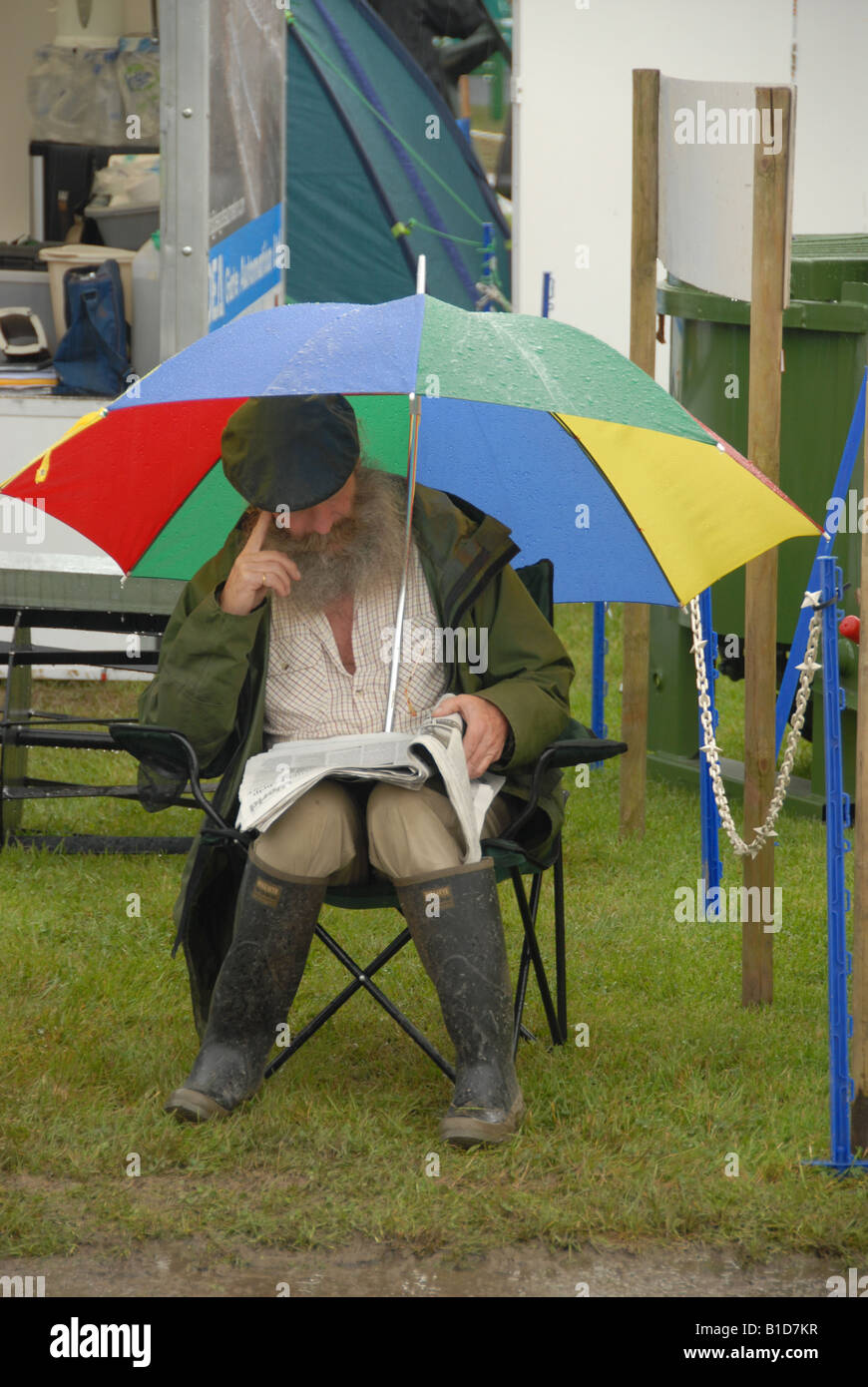 Farmer Sitting Under Umbrella Royal Welsh Show Stock Photo