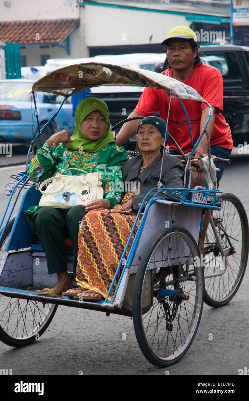 Indonesia Java island Surabaya transportation two women riding on a ...