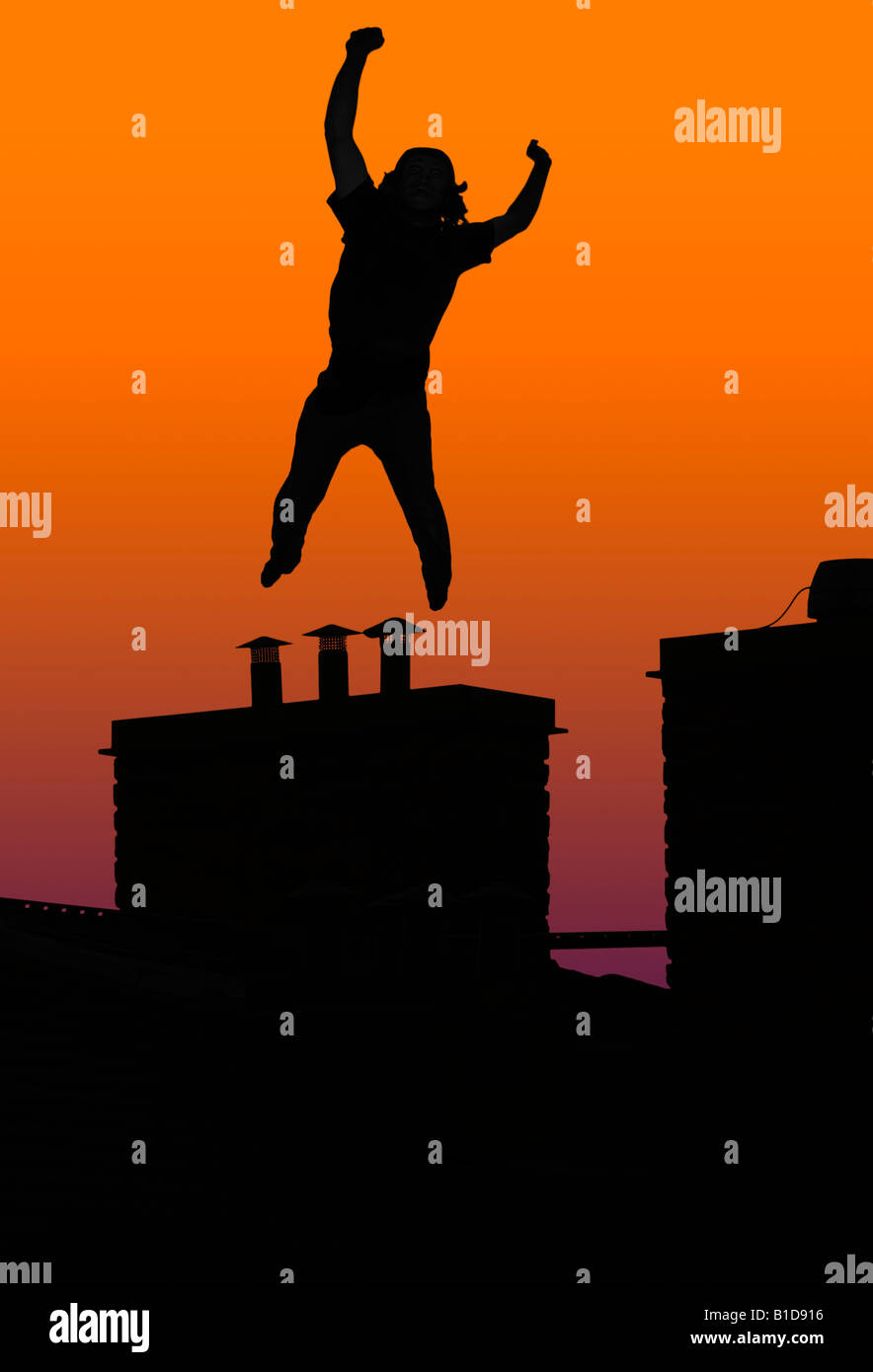 Happy or crazy man jumping on chimney Stock Photo