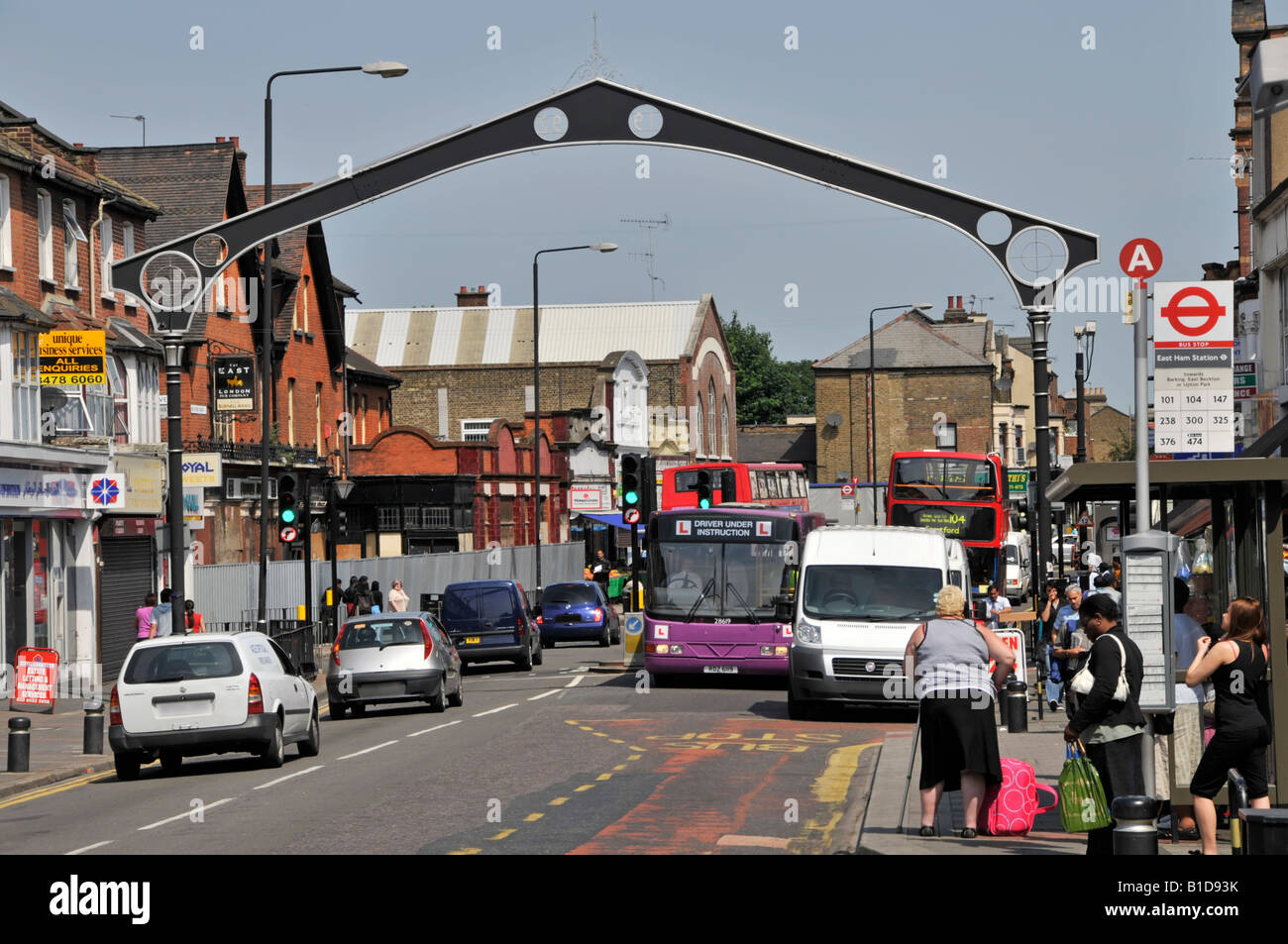 Arch spanning across road on start of East Ham shoppers High Street Stock Photo