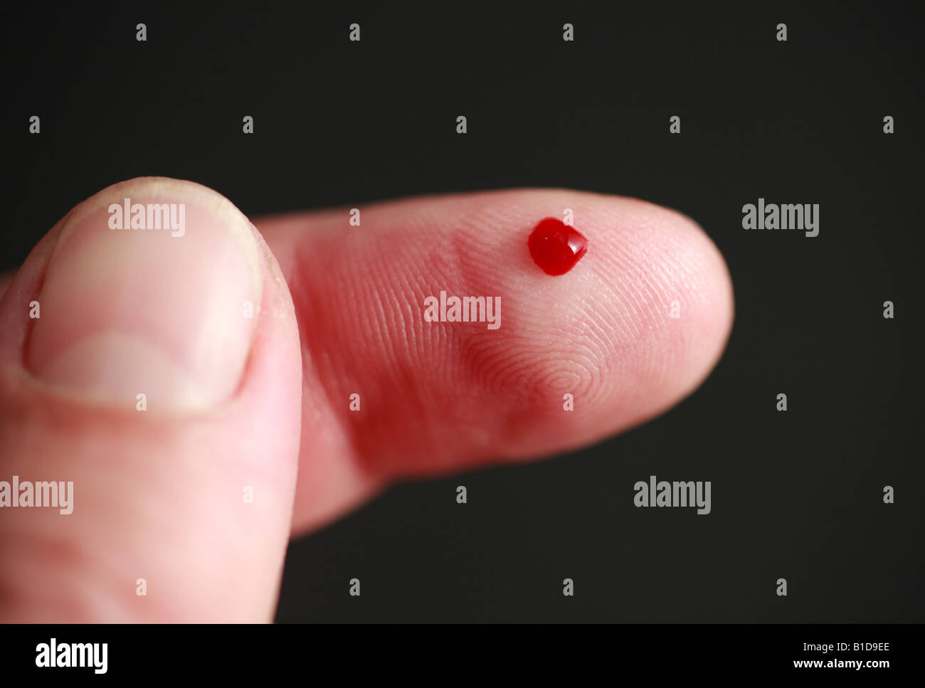 Pinprick and drop of blood on a man's index finger Stock Photo Alamy