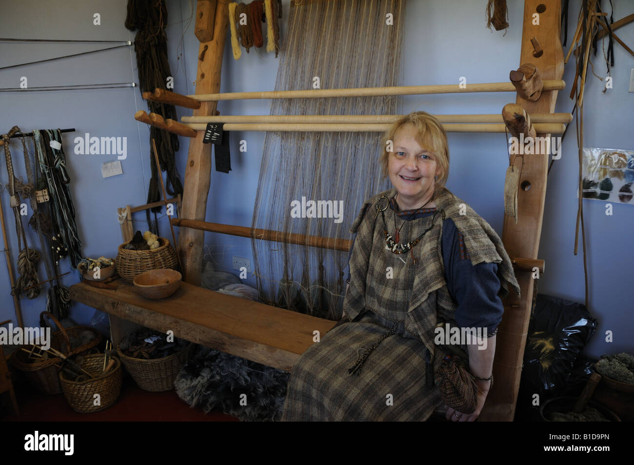 At Scatness in the Shetland Isles, Shetlander Elizabeth Johnston weaves on a loom similar to ones the Vikings would have used. Stock Photo