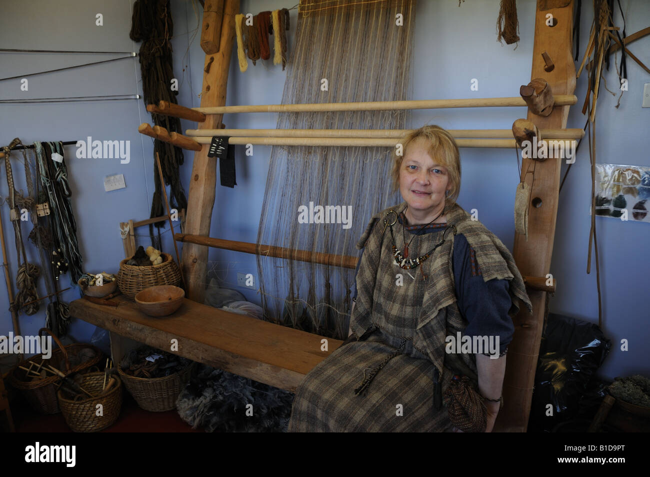 At Scatness in the Shetland Isles, Shetlander Elizabeth Johnston weaves on a loom similar to ones the Vikings would have used. Stock Photo