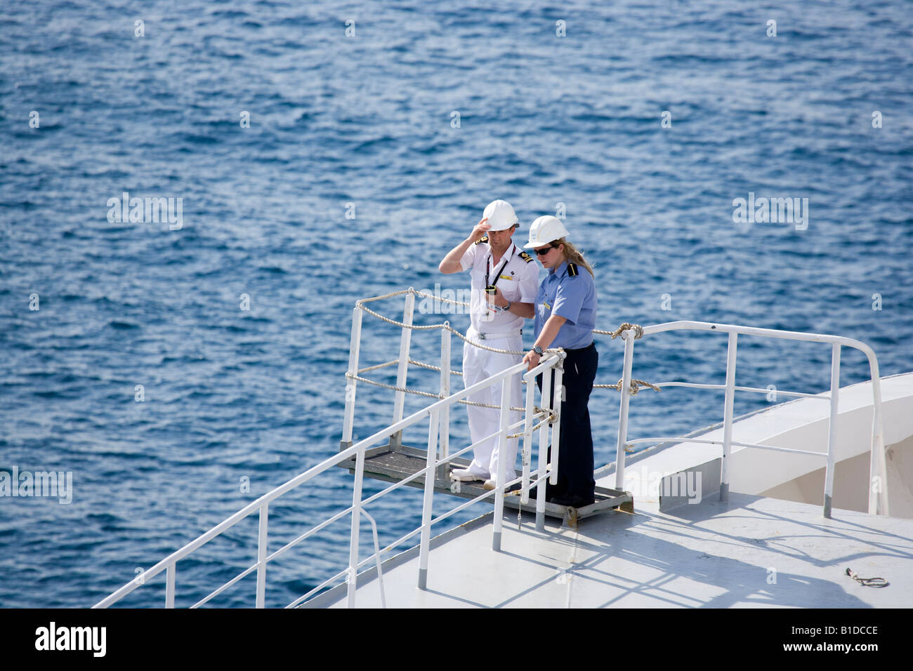 Deck officer on Cunard QE2 instructing a deck cadet watching the anchor being winched Stock Photo