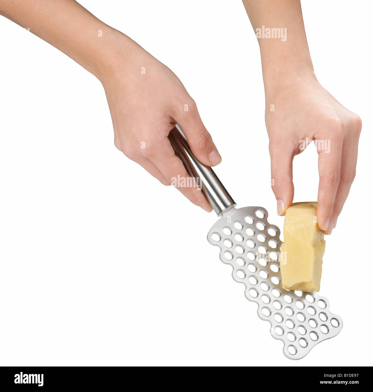 Hands using a cheese grater Stock Photo - Alamy