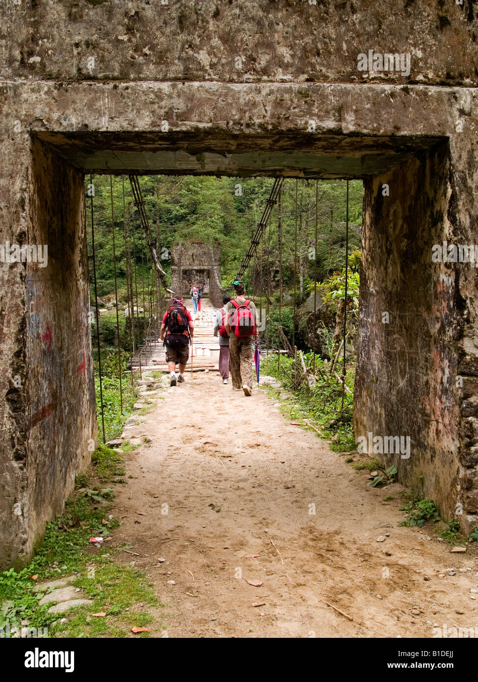 trekkers crossing a bridge on the Singalila Ridge trek along the Nepal India border Stock Photo