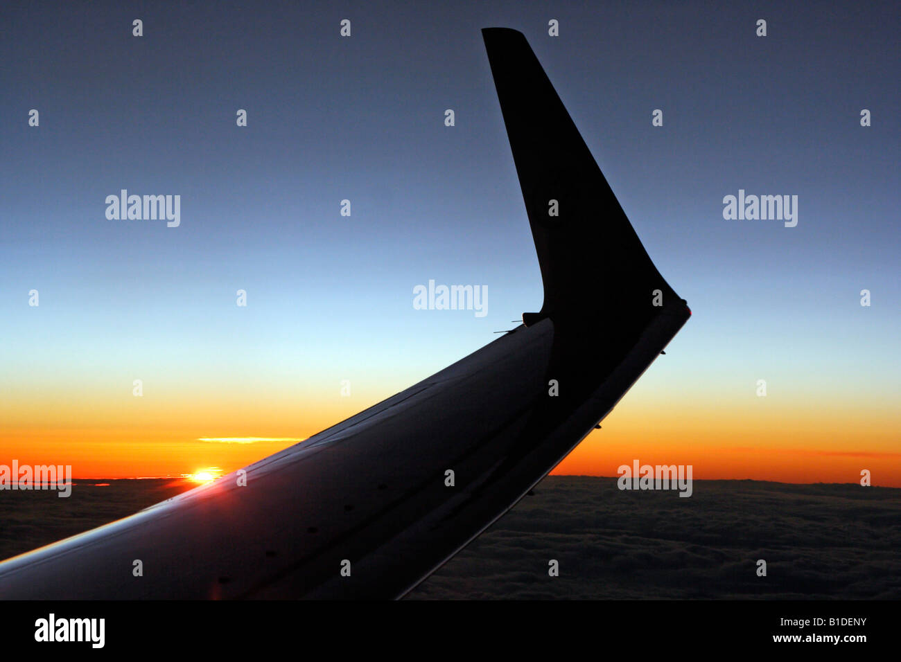 Sunset above the clouds Stock Photo - Alamy