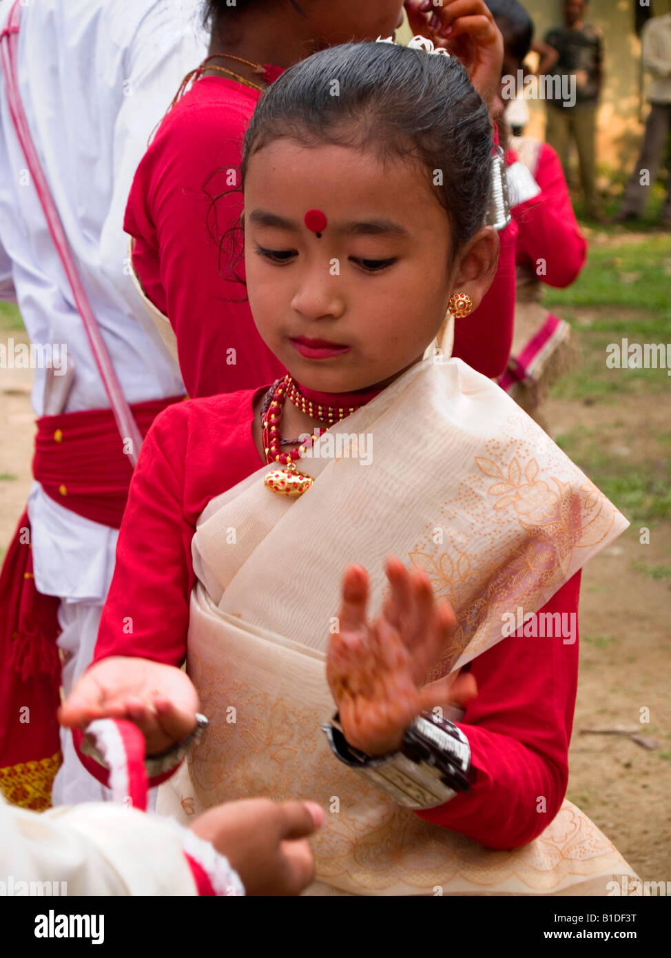 young dancer with henna on her hands at Rongali Bihu Festival for Assamese New Year in India