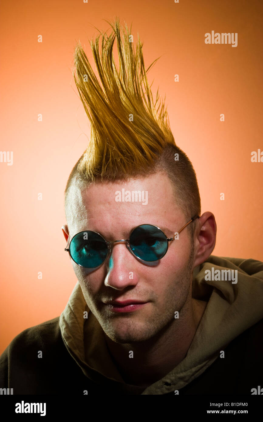 Young man with a Mohawk hairdo wearing glasses posing MODEL RELEASED Stock Photo