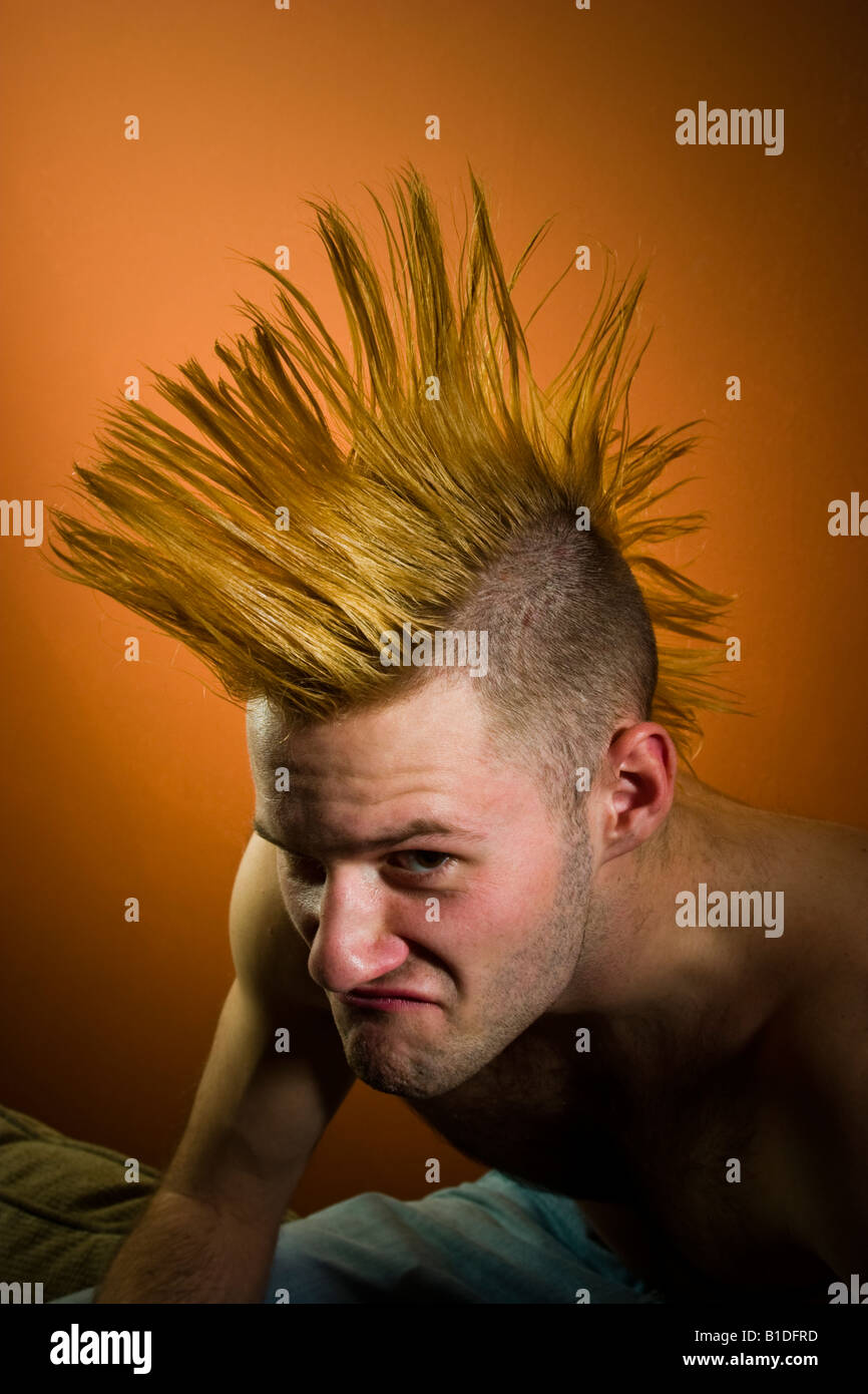 Young man with a Mohawk hairdo posing MODEL RELEASED Stock Photo