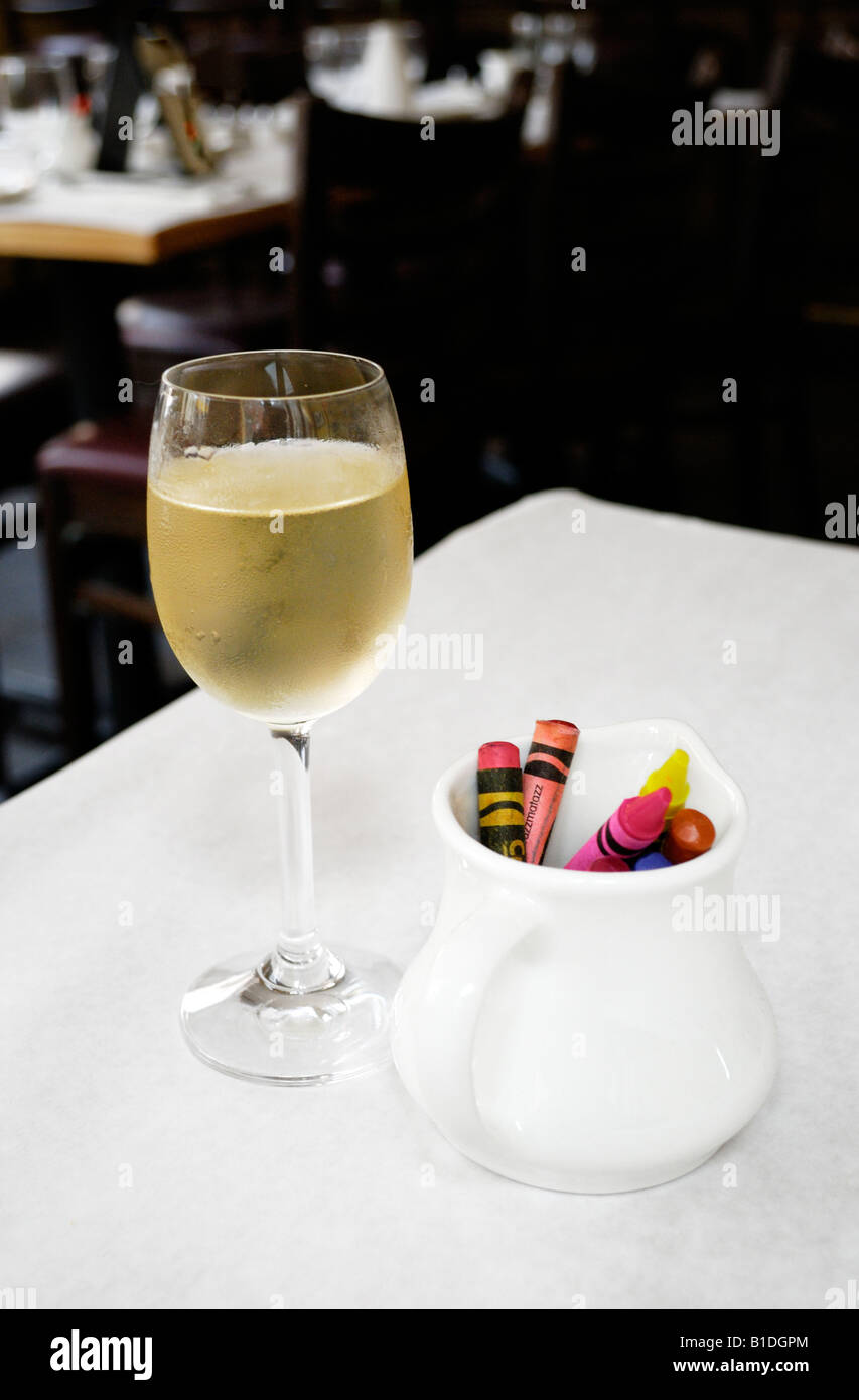 A glass of Muscat de Beaumes de Venise sweet dessert wine and crayons. Stock Photo