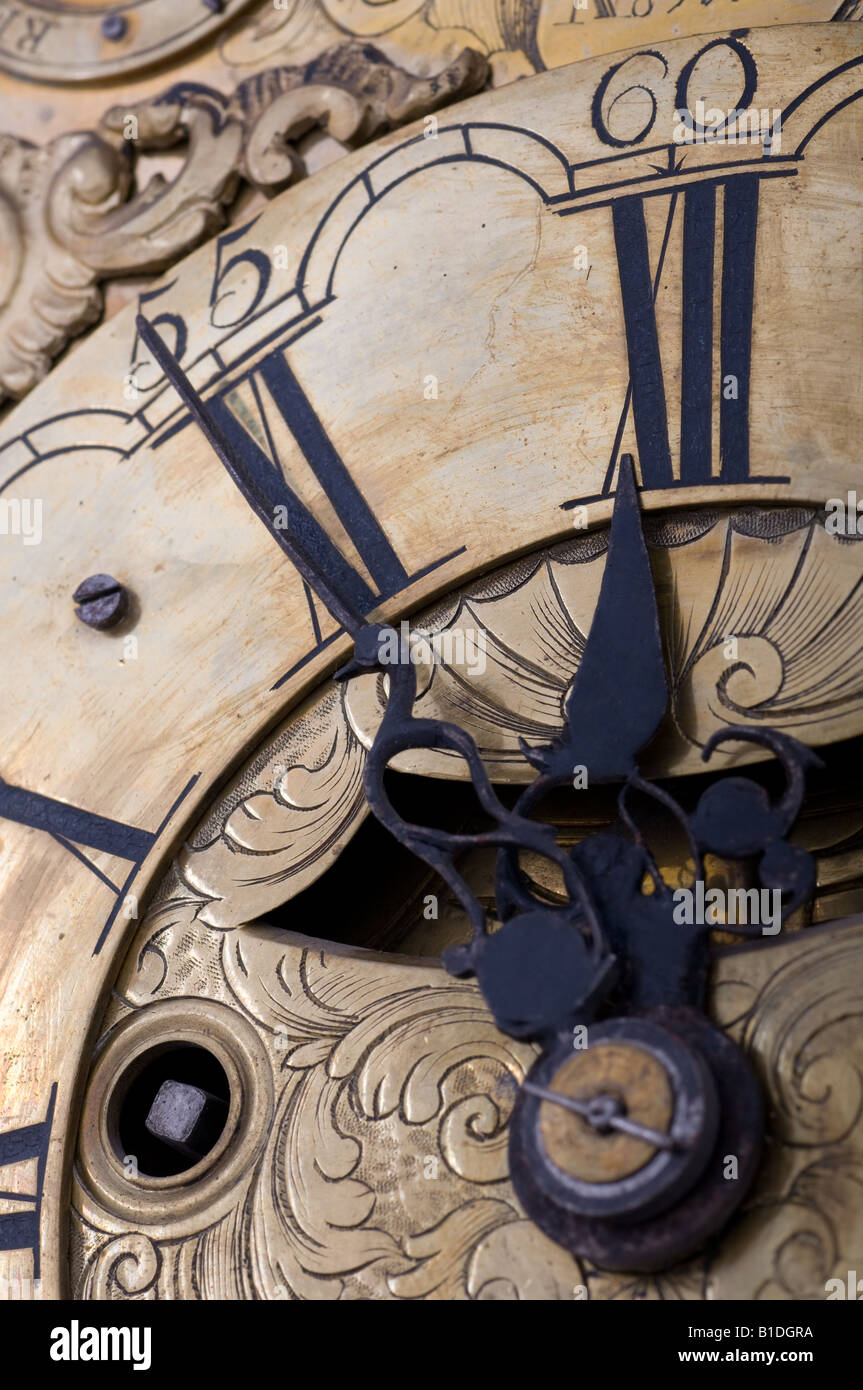 Old clock showing five to twelve on the dial. Stock Photo