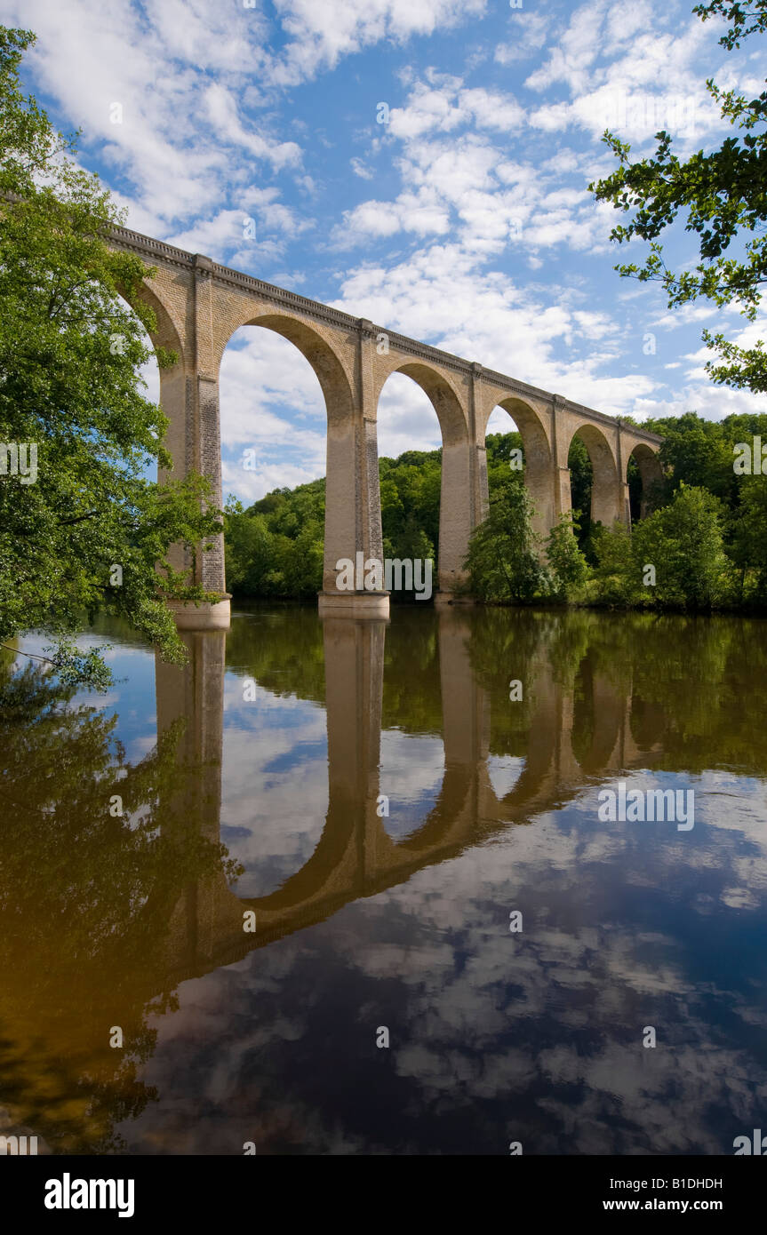 Old railway viaduct reflected in river Creuse, Le Blanc, Indre, France. Stock Photo