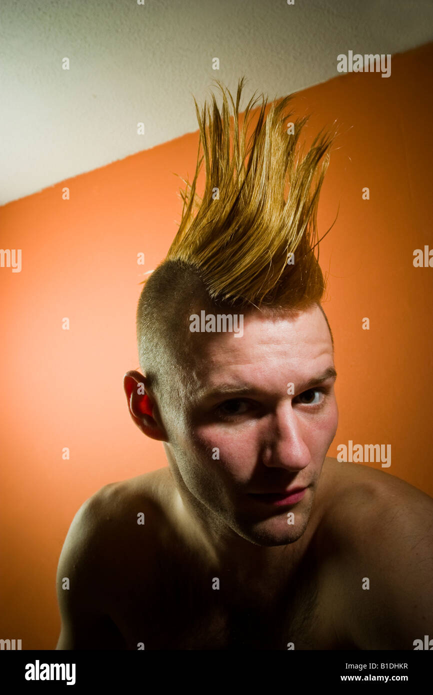 Young man with a Mohawk hairdo posing MODEL RELEASED Stock Photo