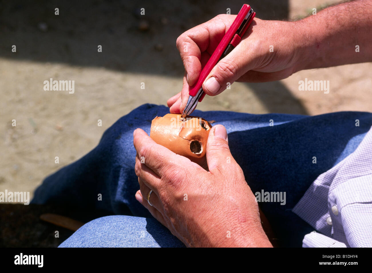 Italy, Sardinia, Sinis peninsula, artisan making mask Stock Photo