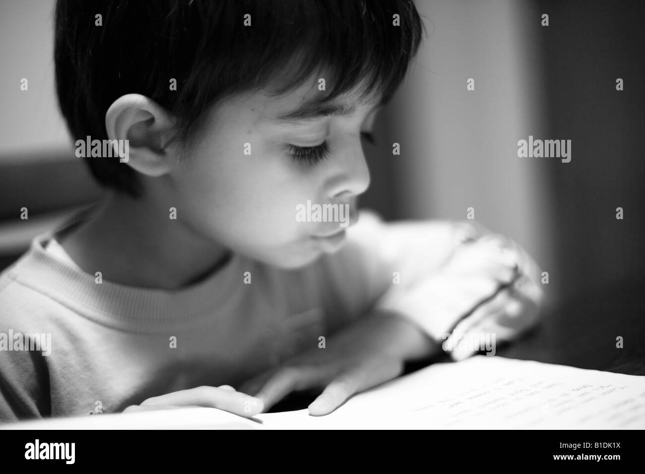 Little boy reading picture book Black and White Stock Photos & Images