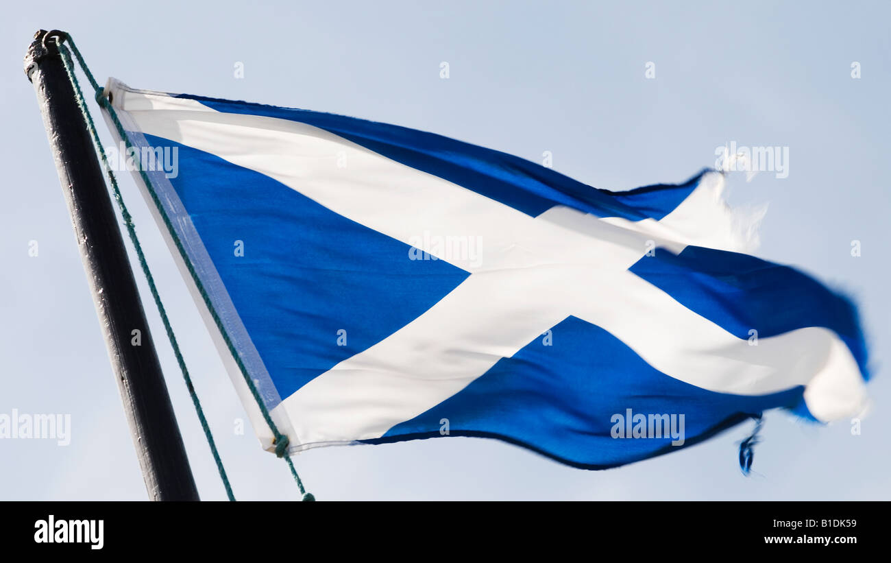 A Scottish Saltire flag blows in the wind. The flag represents the countries patron saint St Andrew. Stock Photo