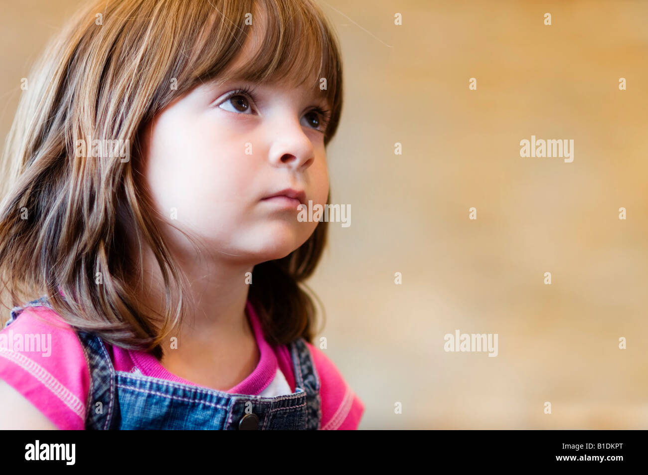 Child looking up at teacher, listening with interest and curiosity. Stock Photo