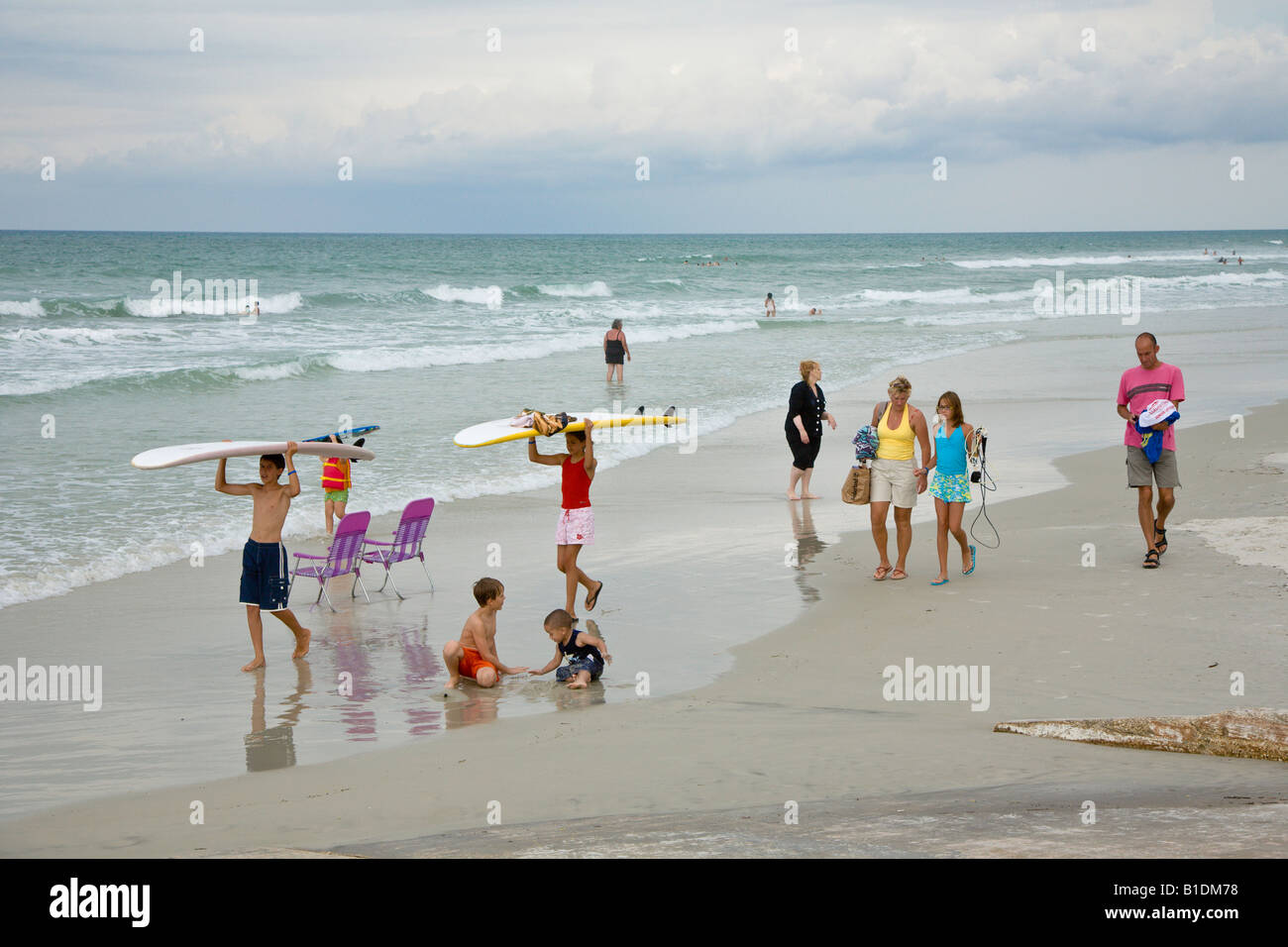 Family Of Surfers Walking Carrying Surf Boards Along Atlantic Ocean Beach At New Smyrna Beach Florida Stock Photo Alamy Family Of Surfers Walking Carrying Surf Boards Along Atlantic Ocean Beach At New Smyrna Beach Florida Stock Photo Alamy